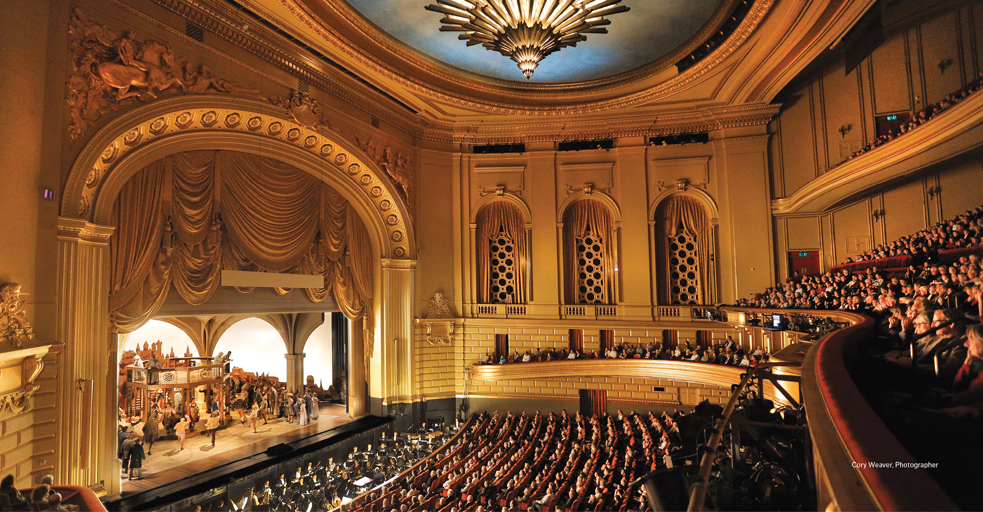 War Memorial Opera House interior house right with production onstage and a live audience. 