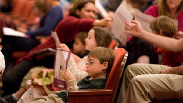 Children at opera reading brochure