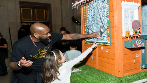 Diversity, Equity and Community event with a child looking at the puppet show prop